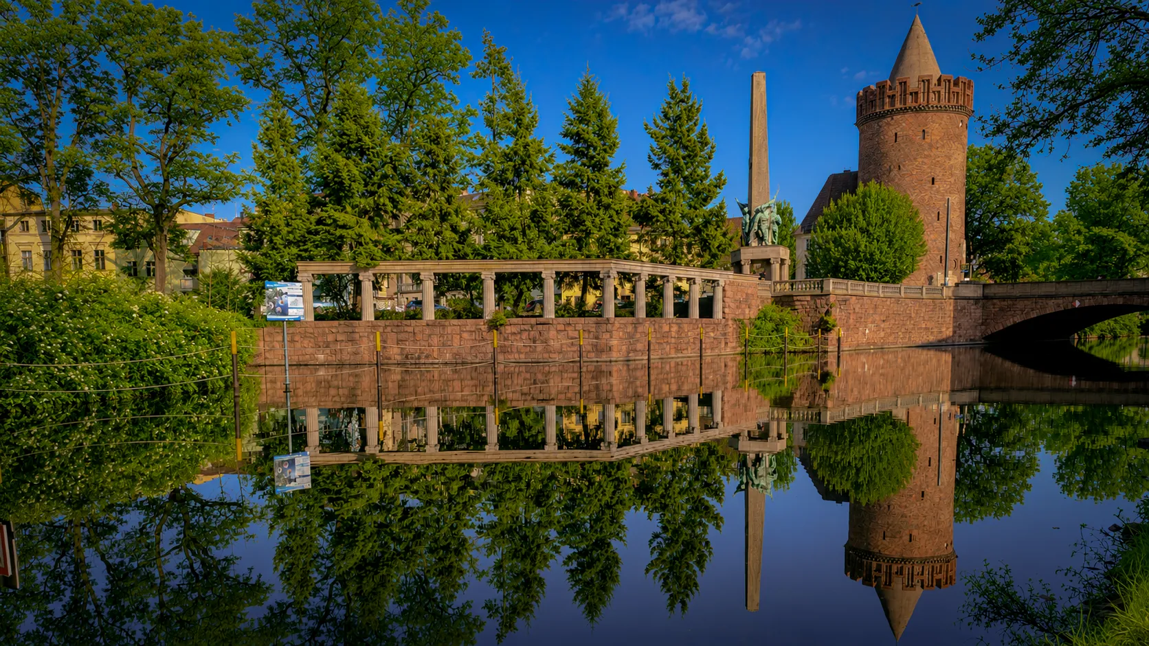 Steintorturm und Ehrenmal am Stadtkanal in Brandenburg an der Havel, gespiegelt im Wasser — Standort und Verlässlichkeit.